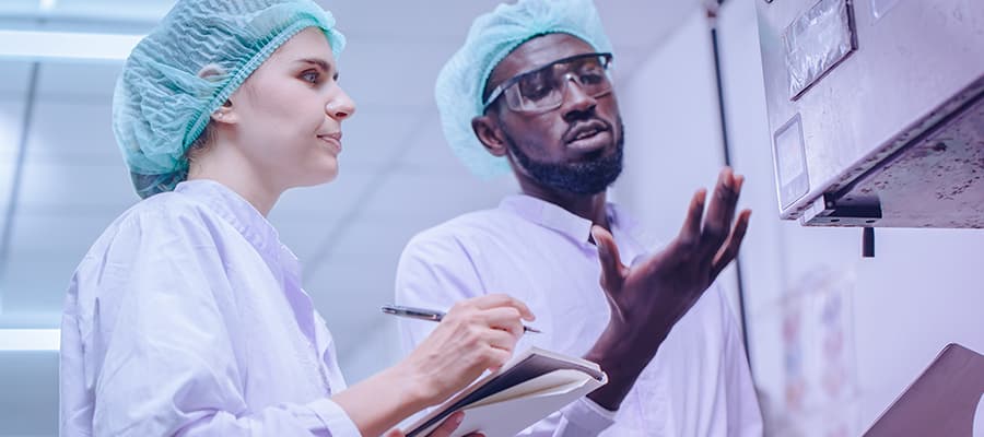 Life sciences manufacturing professionals working on reporting a deviation in the production line.