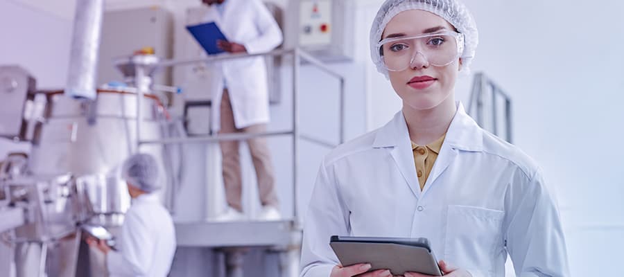 female lab technician holding ipad