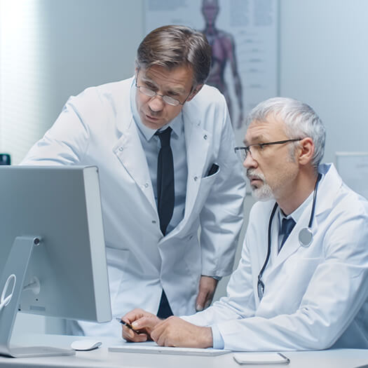 Clinical researchers at a computer
