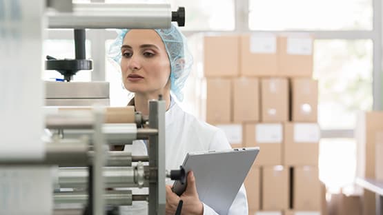 quality-worker-checking-machine-555x312